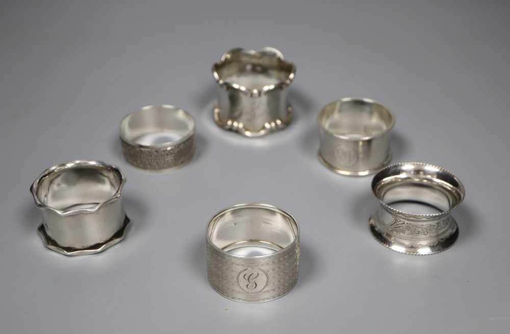 Six assorted silver napkin rings.